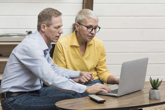 Senior Man Looking Through His Laptop His Wife